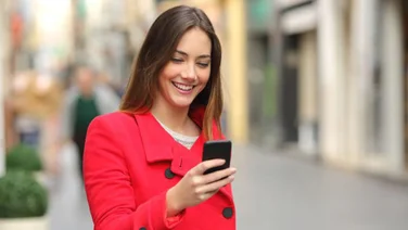 woman walking and looking at phone