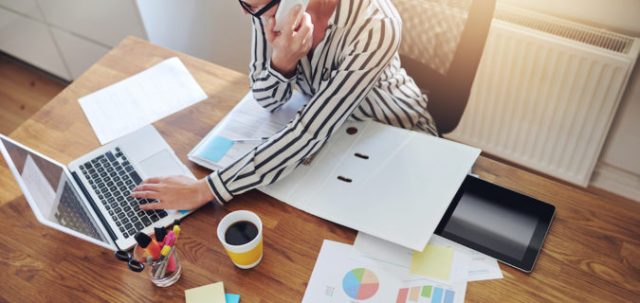 home office desk with woman on phone
