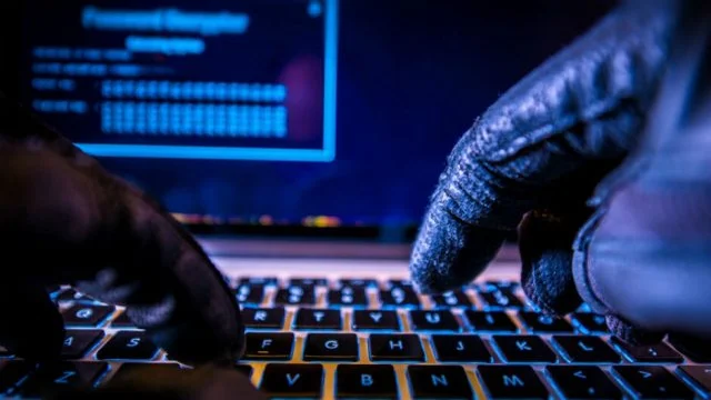Hacker typing on keyboard
