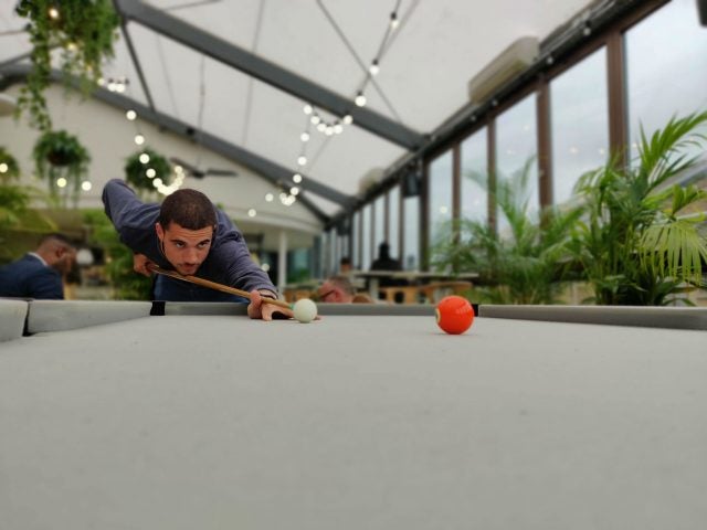 Man playing pool with Bokeh effect taken on OnePlus 7