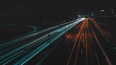 vehicles along freeway at night light painting