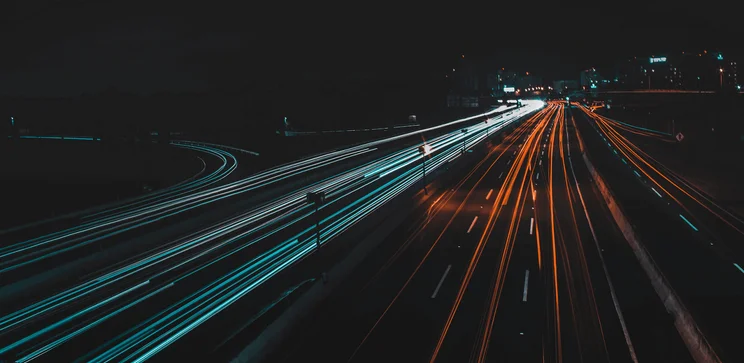 vehicles along freeway at night light painting