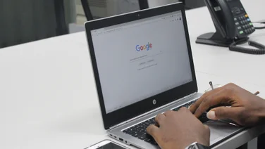 man using google chrome on a laptop