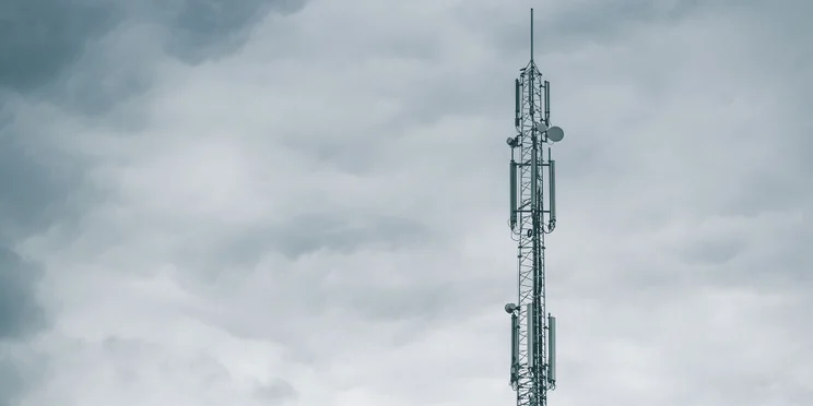 mobile network tower grey clouds