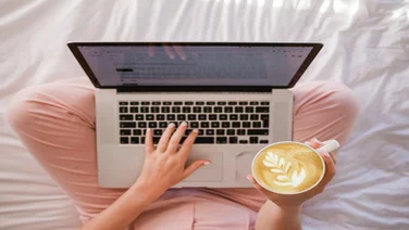 woman at laptop with coffee using Wix