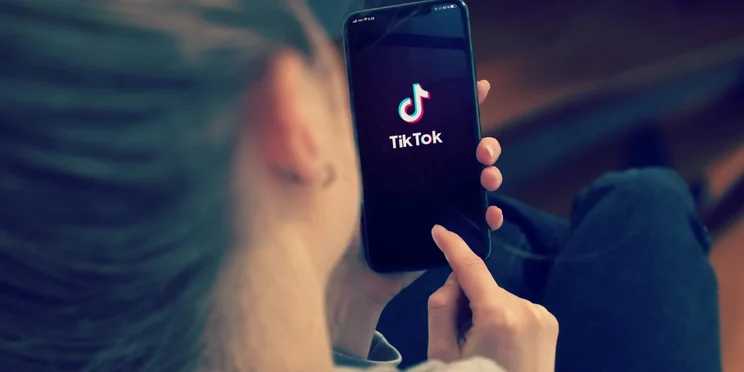 girl looking at tiktok on her phone