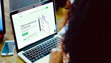 woman at laptop visting freshdesk website