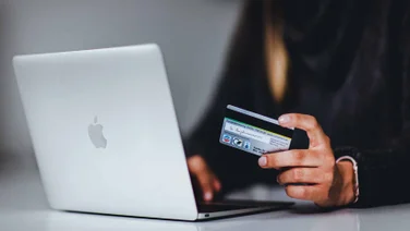woman with credit card using laptop