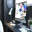 Website builder website open on Mac-like computer on desk in modern workspace