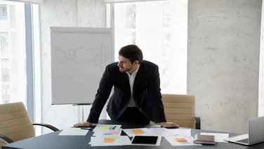 Stressed Out Project Manager with Hands on Table