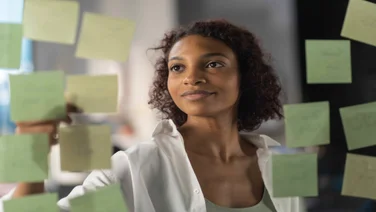 woman working on kanban board with post its