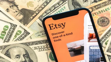 Etsy logo on top of US dollars