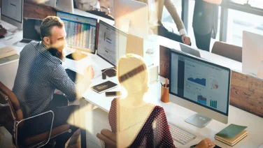 Concept of busy sales team using CRM like software in office