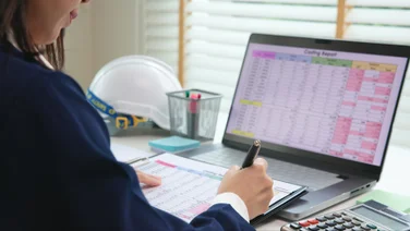 Person doing accounting on a laptop.