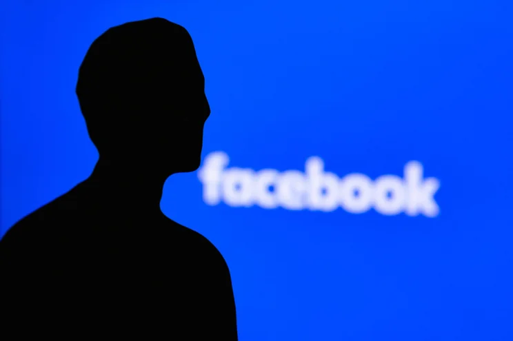 Facebook logo with Zuckerberg silhouette