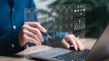 A graphic showing a perosn using a calendar in their project management software.