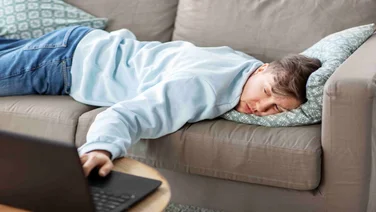 Man on sofa looking at computer