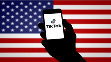 TikTok logo against US flag