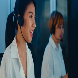 A woman making a call on a VoIP system.
