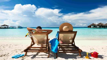 Workers on Holiday sat on beach