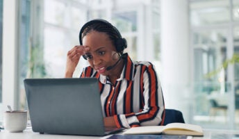 Woman working at desk with headset on
