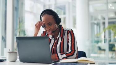 Woman working at desk with headset on