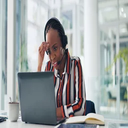 Woman working at desk with headset on