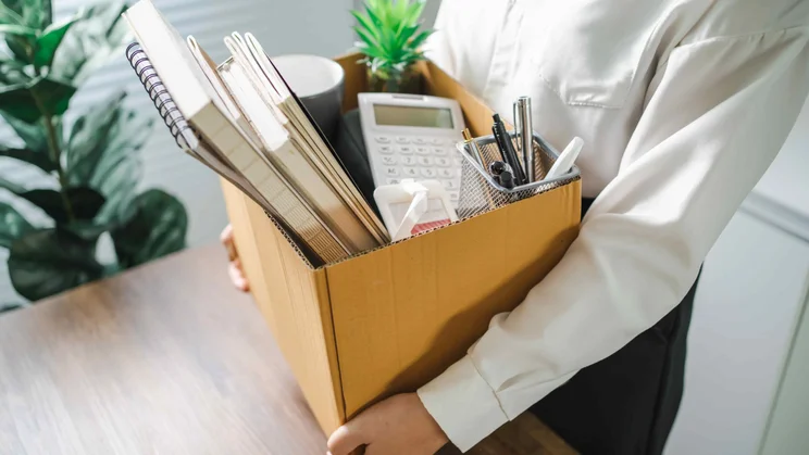 Man packing up belongings from office