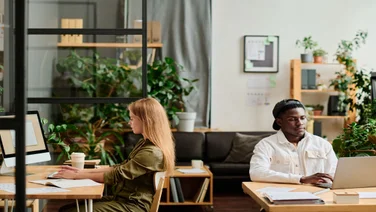 Two young employees working side by side