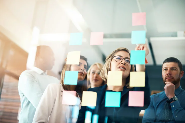 Employees collaborating with post-it notes
