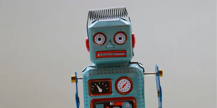 A confused looking robot against a neutral background