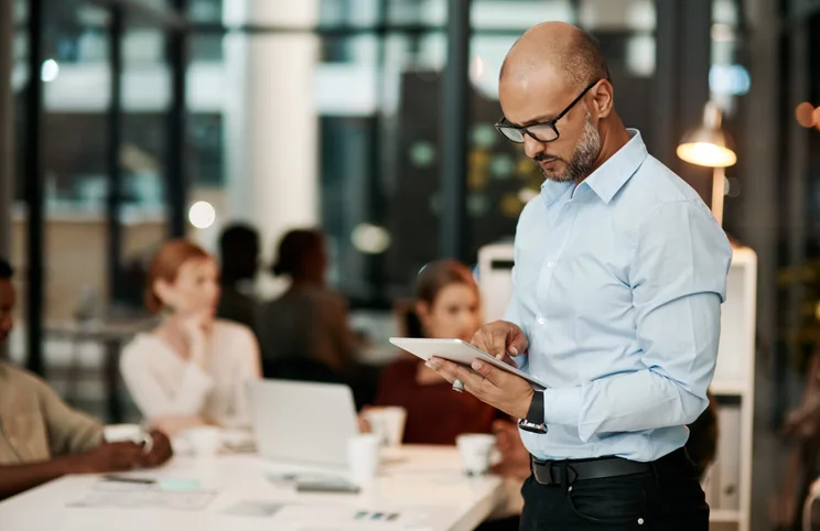 Man on tablet in office