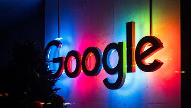 Google's office logo lit up at night