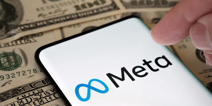 Phone with meta logo on bed on money