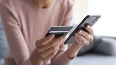 Woman with smartphone and credit card