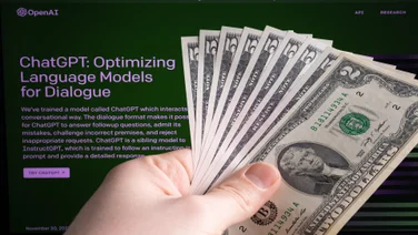 chatgpt login page with hand holding cash