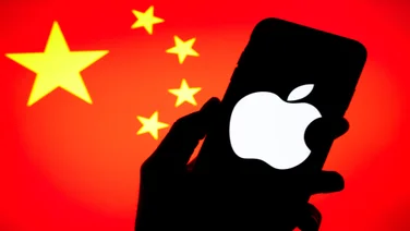 silhouette of hand holding a iPhone in front on a China flag