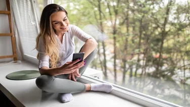 Lady using a mental health app on a window