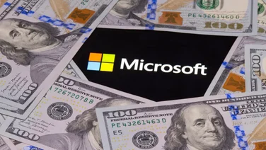 Microsoft logo surrounded by $100 bills