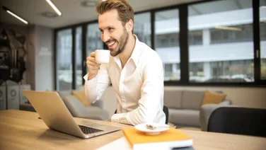A man drinks coffee at work.