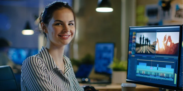 woman sat at desk editing video