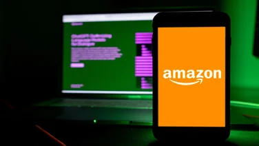 Amazon logo on phone in front of ChatGPT screen