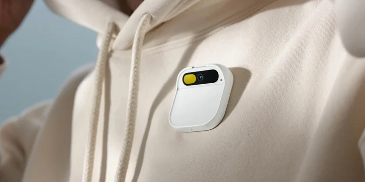 Humane AI Pin clipped on to a beige hoodie