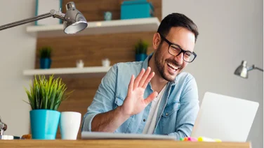 man waving on video call