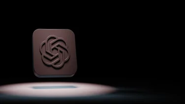 OpenAI logo in spotlight against black background