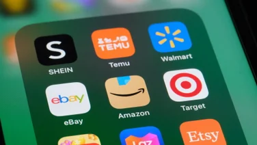 Online shopping app icons including Temu and Amazon on phone screen