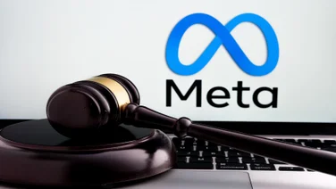 meta logo on screen with gavel on keyboard