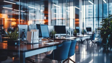 Desks, chairs and monitors in a sleek company office
