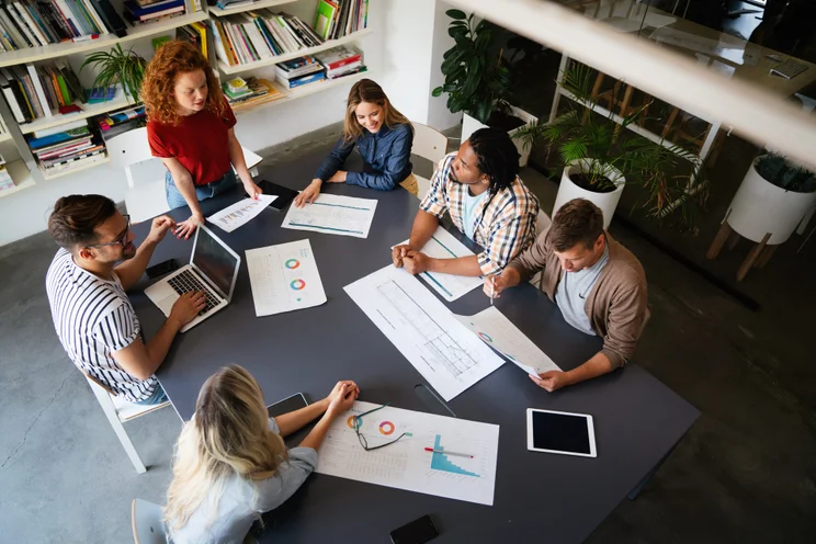 Employees sat round a take in a startup