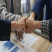 Businesspeople bump fists to celebrate successful project coordination and management